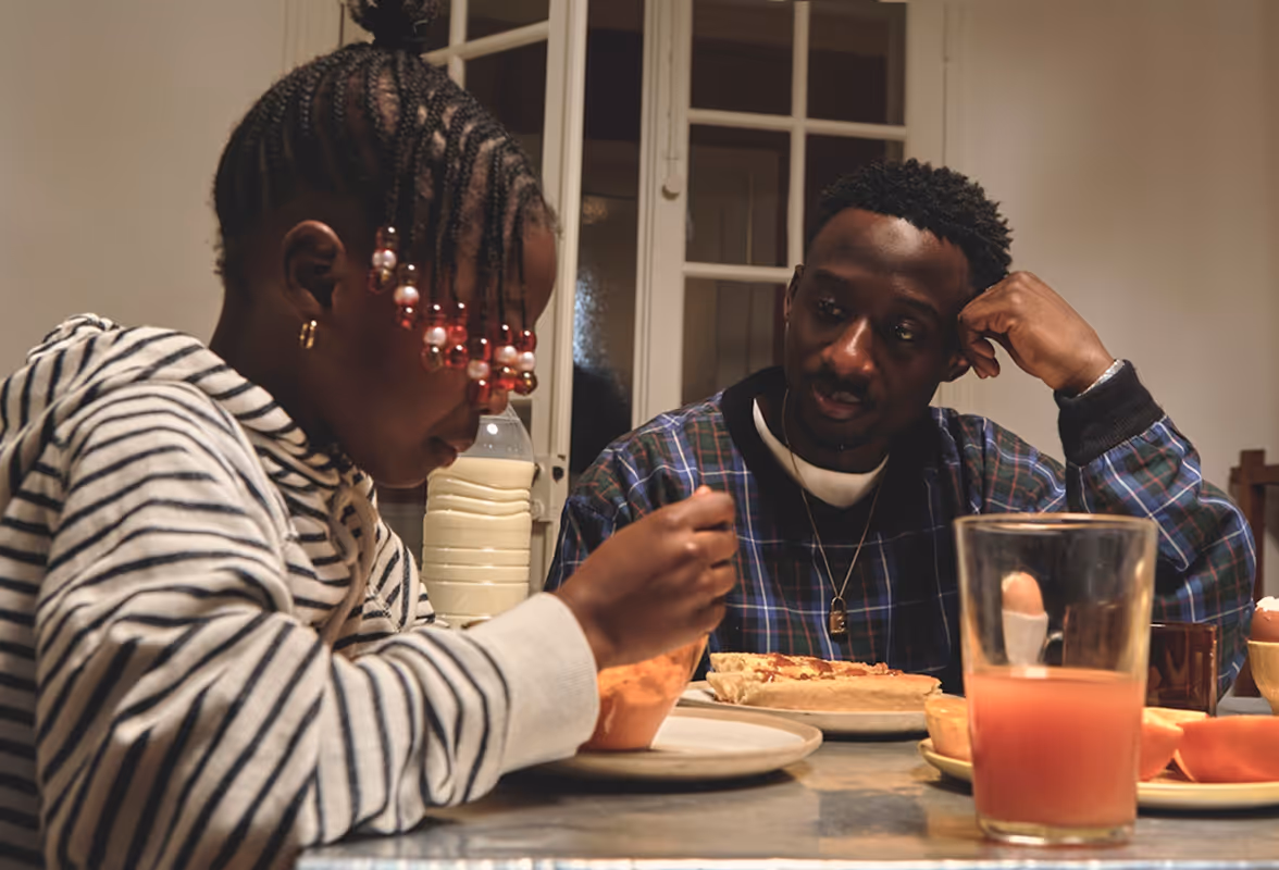 Father looking at his child eating. Both at the dinner table, tungsten cozy lighting. Found on Death to Stock "FATHERHOOD" Shot by Ahmed CHREDIY