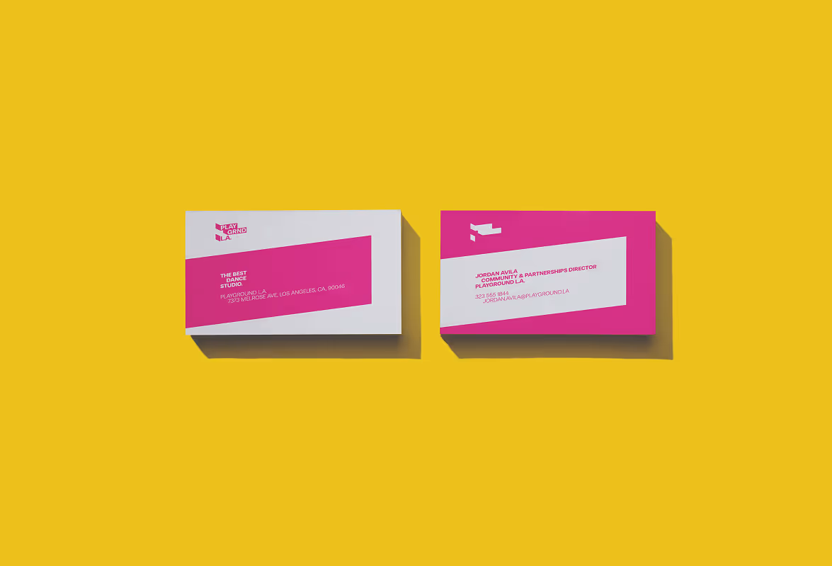 Bird's eye view of L.A. magenta and white business card on a bright yellow background. Source : Mockup Maison