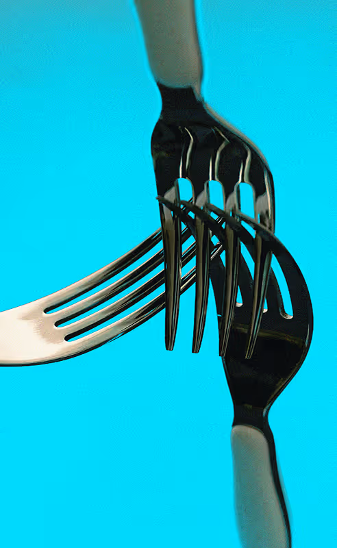 Forks interlocking eachother in a light and saturated blue background. Edited, but Found on Death to Stock : "GILDED CRAVINGS" shot by Daniel Farò
