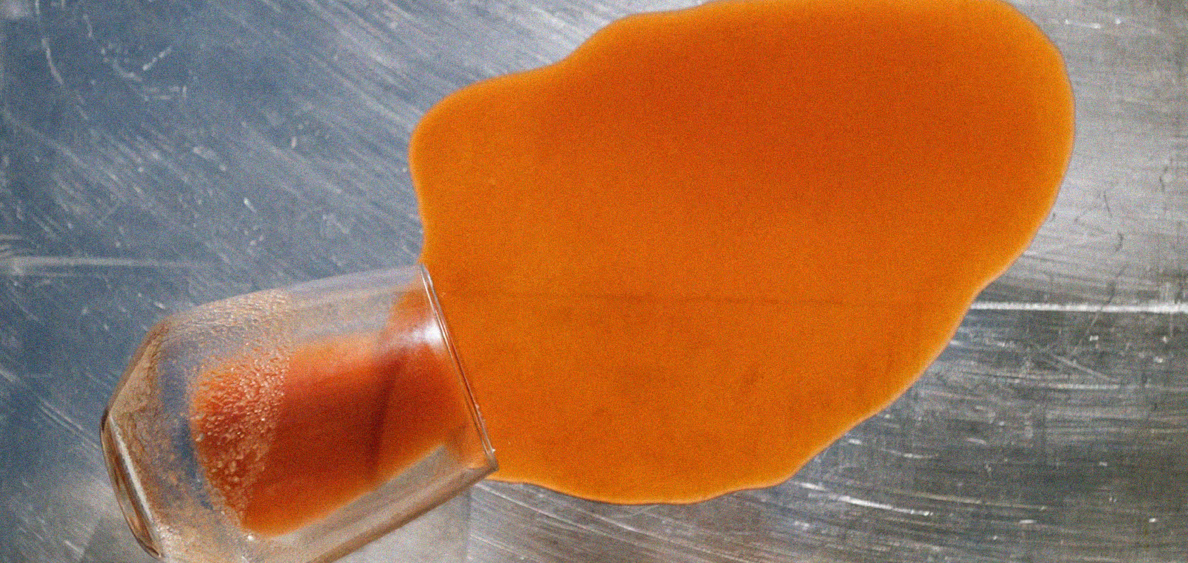 Spilled orange drink on stainless steel countertop. Found on death to Stock : PLATING shot by Chris Abatzis